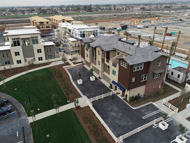 aerial view of multiple residential buildings at various stages of construction process