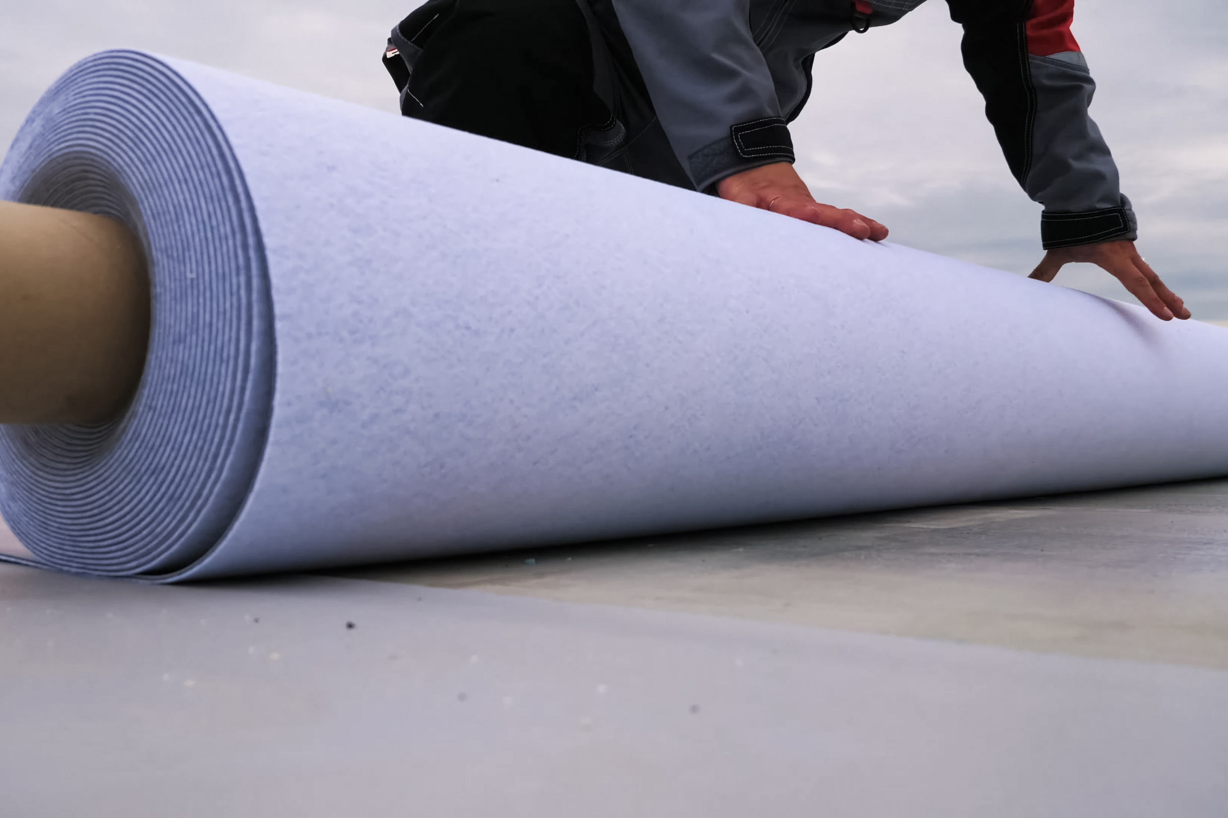 close-up of waterproofing material being rolled out